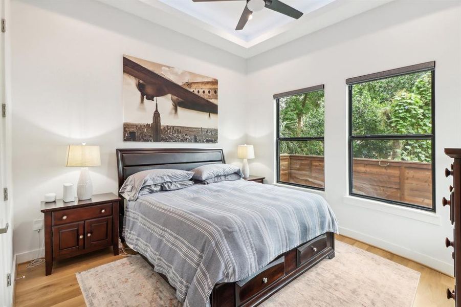 This is the downstairs bedroom with coffered ceilings and windows facing the backyard.