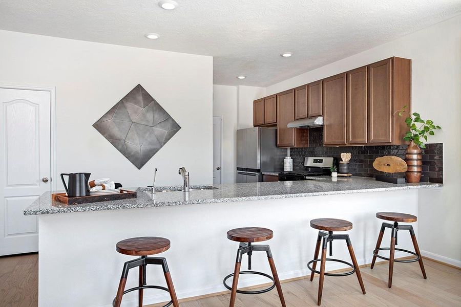 This spacious kitchen has it all—ample storage, generous counter space, and a layout that truly makes it the heart of the home.