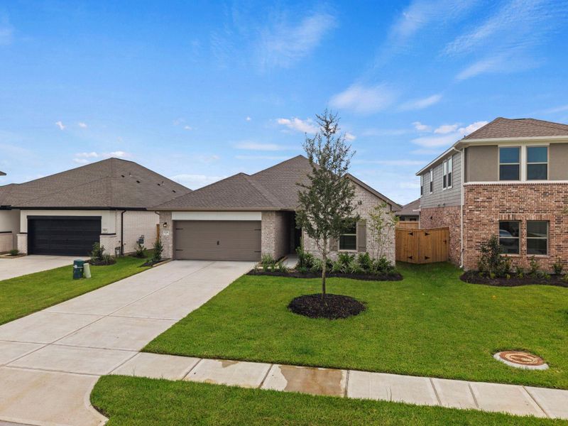 Front exterior of a new home in Windrose Green, Angleton, TX, highlighting curb appeal (Image 14). Front exterior of a new home in Windrose Green, Angleton, TX, highlighting curb appeal (Image 14).