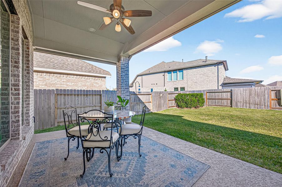 Wonderful covered patio with a ceiling fan, perfect for enjoying those hot summer days. (Note: Photo is staged; property is currently vacant.) Wonderful covered patio with a ceiling fan, perfect for enjoying those hot summer days. (Note: Photo is staged; property is currently vacant.)