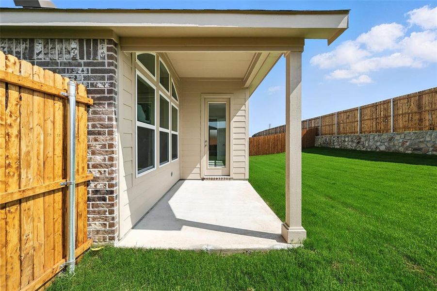 Fenced backyard with a patio
