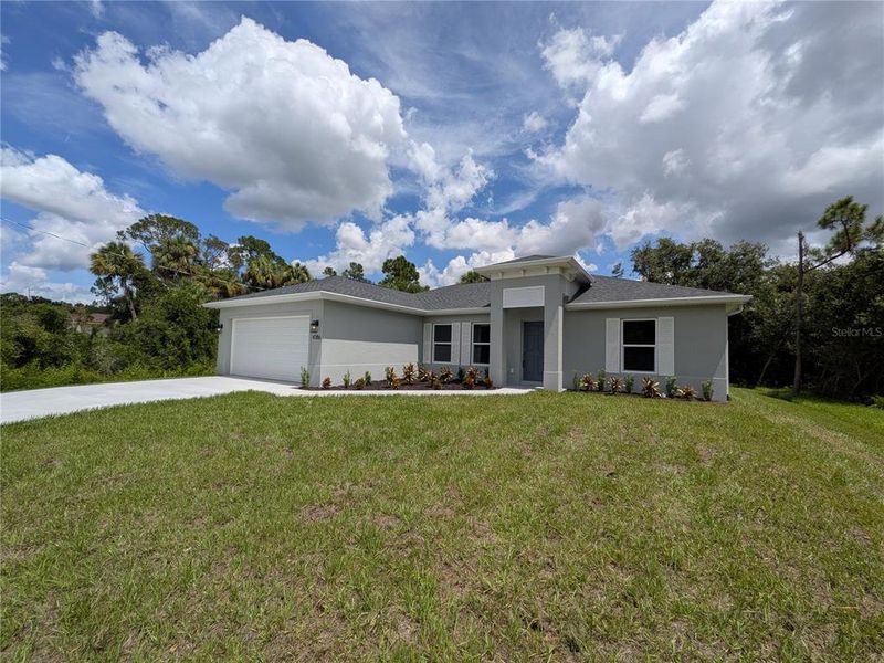 Front exterior of a new home in , North Port, FL, highlighting curb appeal (Image 2). Front exterior of a new home in , North Port, FL, highlighting curb appeal (Image 2).