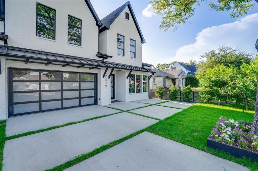 View of front facade with a front yard and a garage