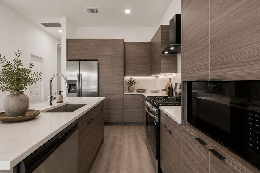 Contemporary island kitchen featuring quartz countertops, stainless steel appliances, soft-close cabinetry, and modern designer finishes throughout.