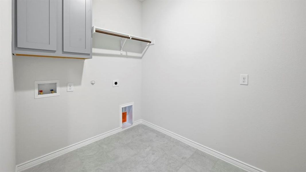 Laundry room with gas dryer hookup, cabinet space, hookup for a washing machine, and electric dryer hookup Laundry room with gas dryer hookup, cabinet space, hookup for a washing machine, and electric dryer hookup