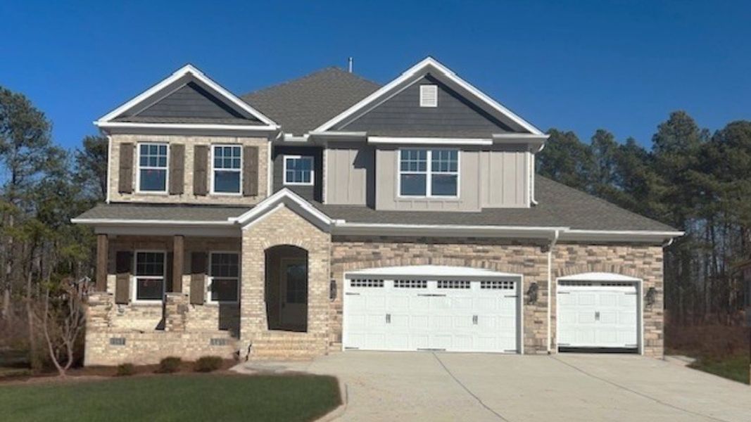 Front exterior of a new home in Preserve at Carriage Cove, Oak Ridge, NC, highlighting curb appeal (Image 1). Front exterior of a new home in Preserve at Carriage Cove, Oak Ridge, NC, highlighting curb appeal (Image 1).