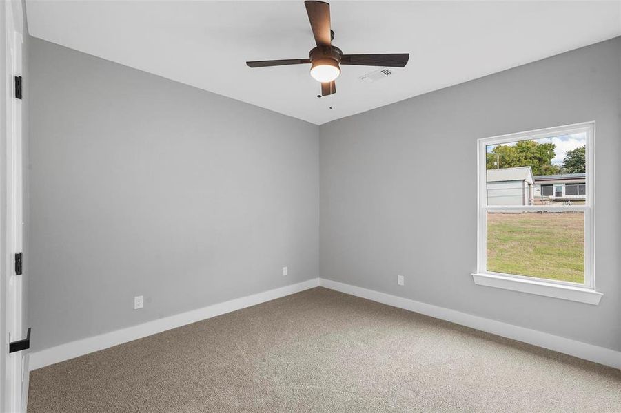 Spare room featuring carpet floors and ceiling fan