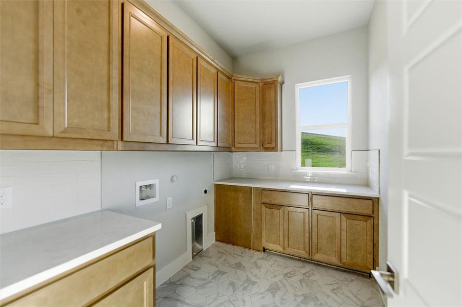 Laundry room with washer hookup, electric dryer hookup, cabinet space, and hookup for a gas dryer