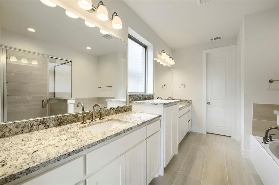 Dual vanity with granite countertops, undermount sinks, and brushed nickel fixtures Dual vanity with granite countertops, undermount sinks, and brushed nickel fixtures
