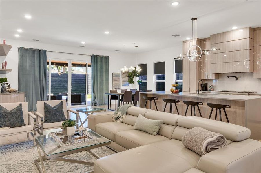 Living room featuring an inviting chandelier and sink