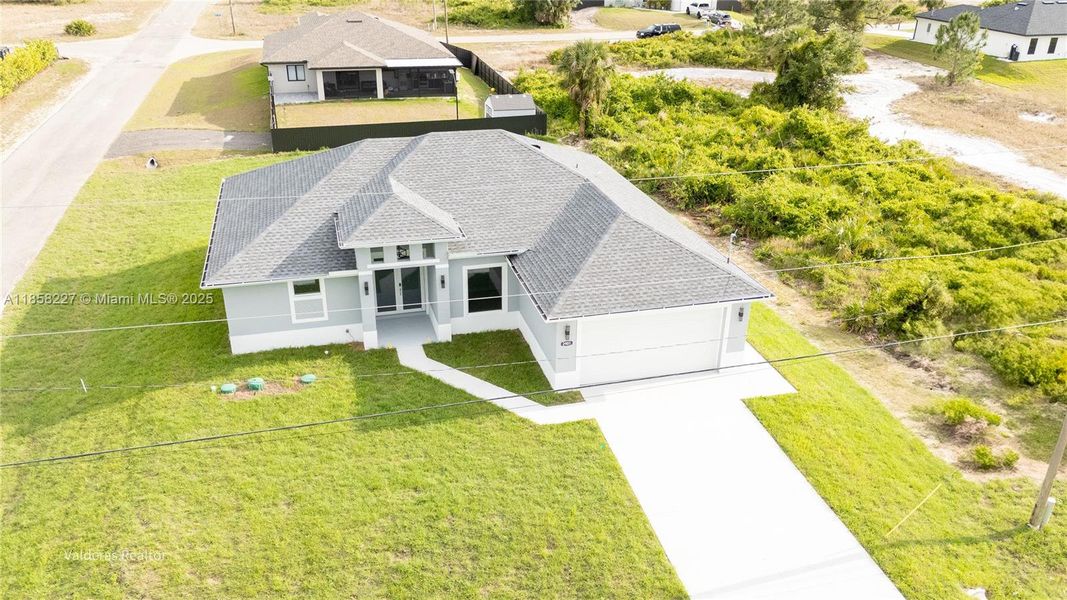 Front exterior of a new home in , Lehigh Acres, FL, highlighting curb appeal (Image 1).