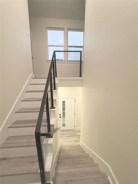 Staircase with hardwood / wood-style floors