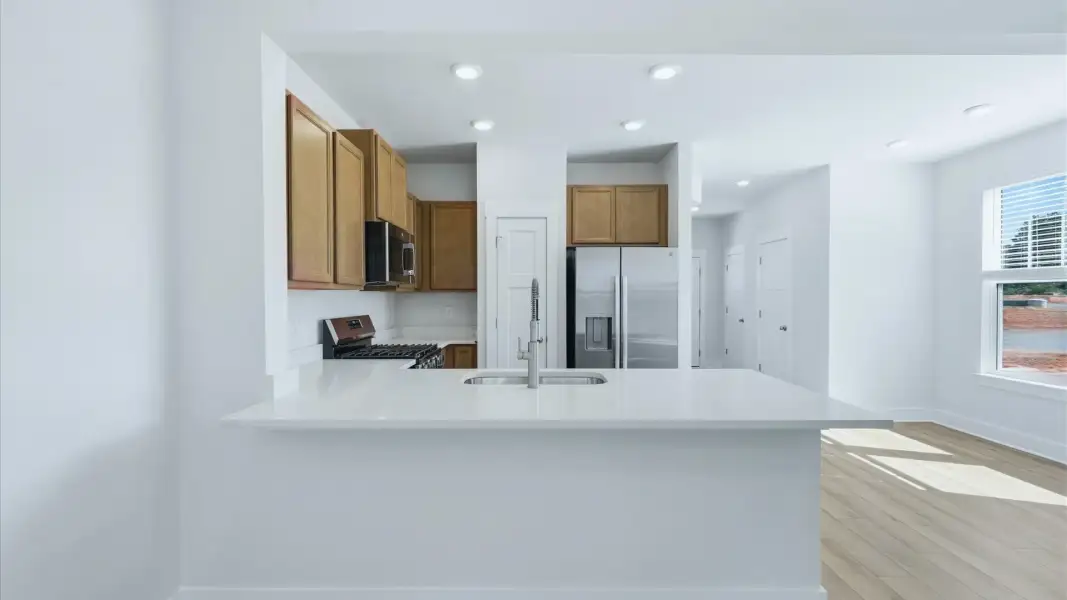 Open-concept kitchen designed to maximize both efficiency and entertaining potential at Clarke Townes
