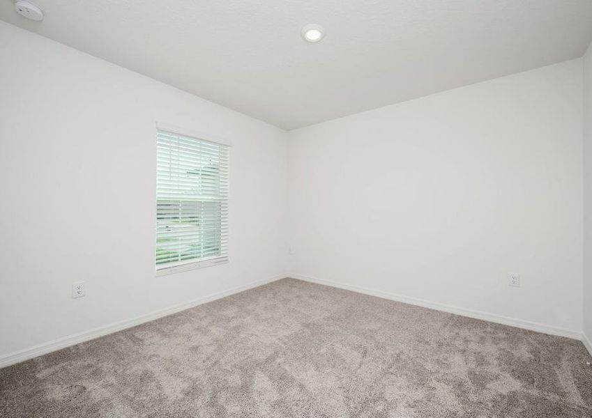 The guest bedroom is spacious and has plenty of natural light