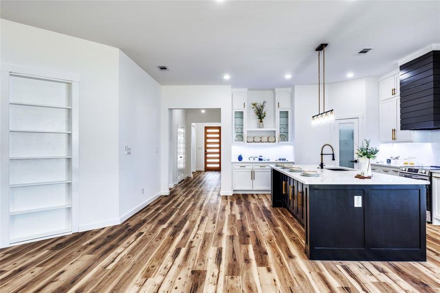 Kitchen featuring open shelves, white cabinets, dark cabinetry, pendant lighting, and recessed lighting