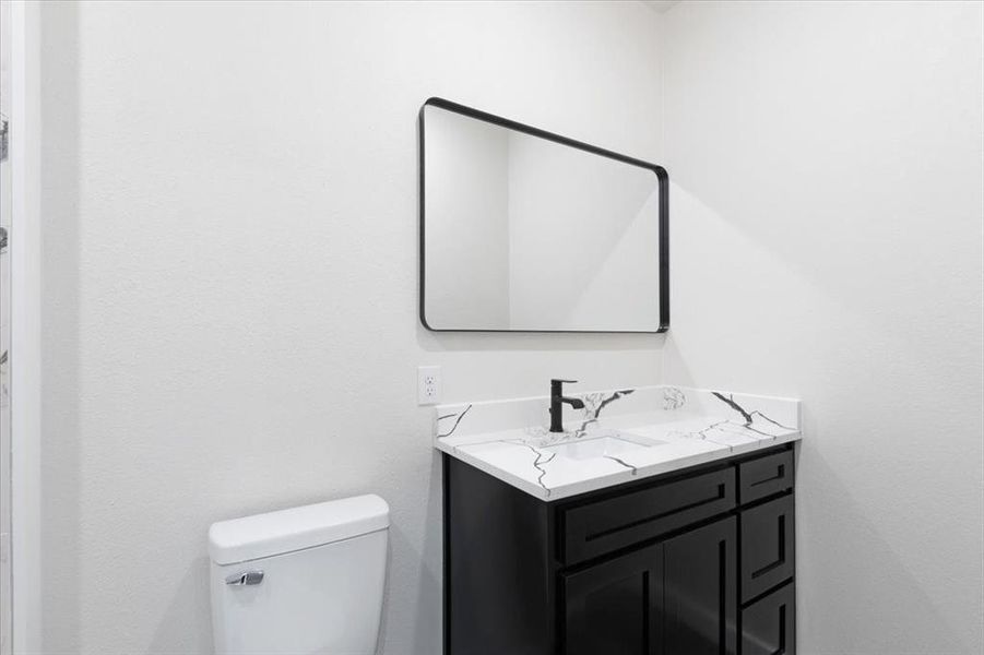 Bathroom featuring vanity and toilet