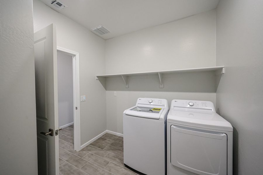 A laundry room with a washer and dryer. A laundry room with a washer and dryer.