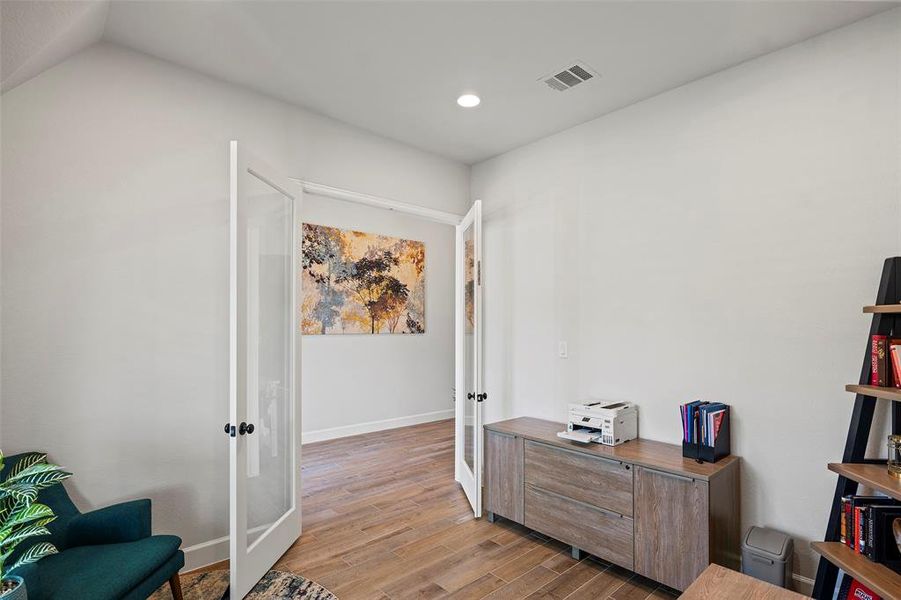 The home office is just off the entryway, private with double doors