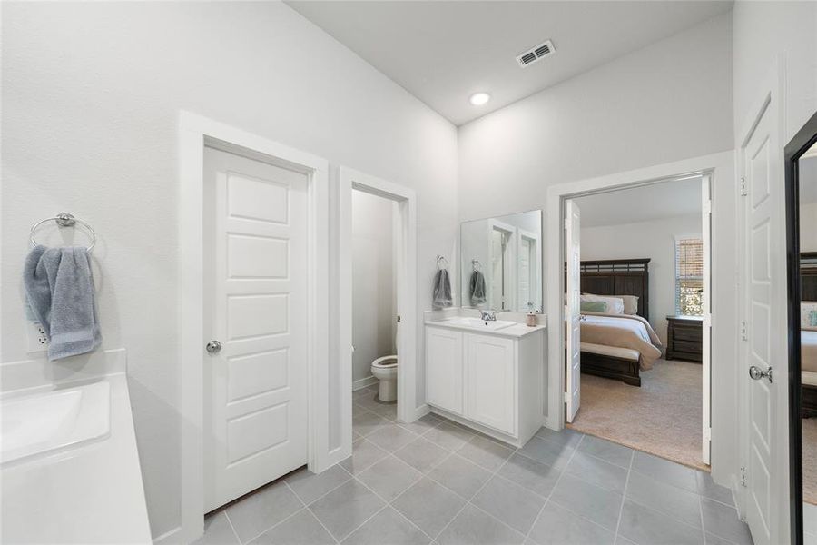 Bathroom with tile patterned flooring, vanity, and toilet