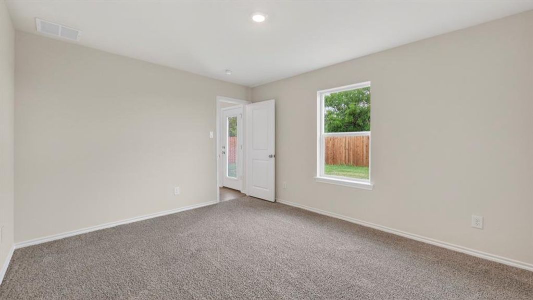 Carpeted room with neutral wall tones and white trim