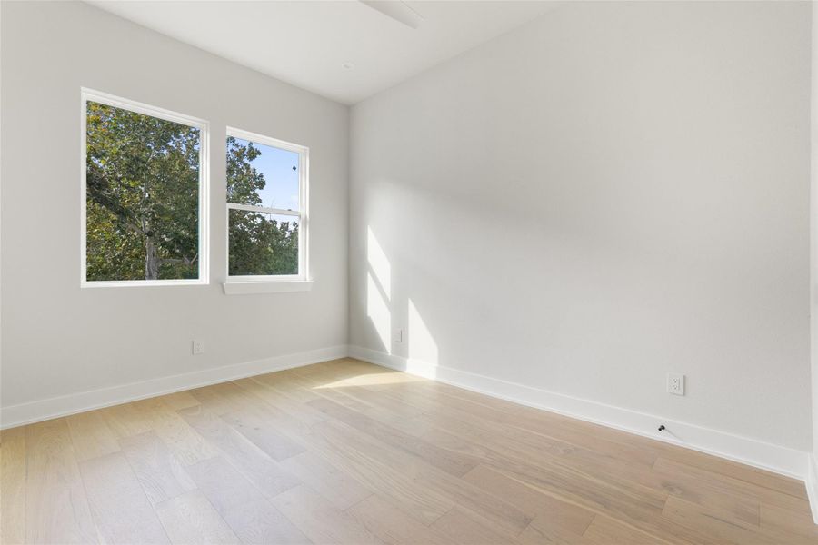 Unfurnished room with light wood-type flooring and baseboards Unfurnished room with light wood-type flooring and baseboards