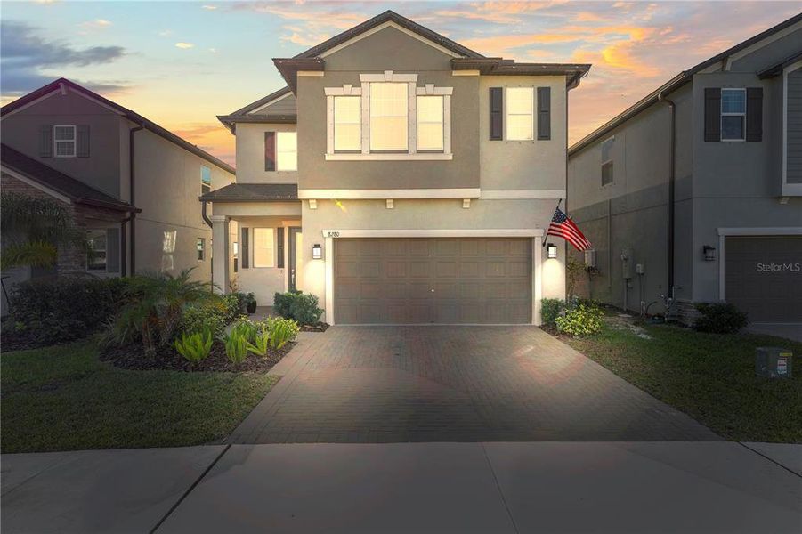 Front exterior of a new home in Bryant Square: The Manors, New Port Richey, FL, highlighting curb appeal (Image 26).