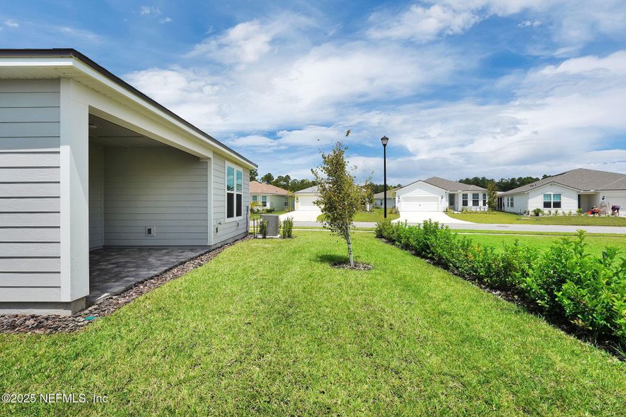 Front exterior of a new home in Summer Bay at Grand Oaks, St. Augustine, FL, highlighting curb appeal (Image 20).