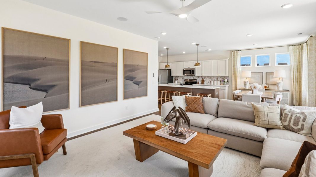 Gathering room with ceiling fan, windows, and fireplace Gathering room with ceiling fan, windows, and fireplace