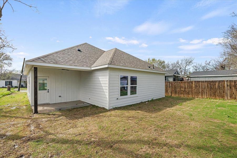 View of home's exterior featuring a patio area, a shingled roof, and board and batten siding