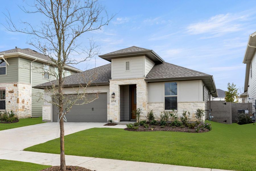 Front exterior of a new home in Discovery Collection at Painted Tree Village, McKinney, TX, highlighting curb appeal (Image 2). Front exterior of a new home in Discovery Collection at Painted Tree Village, McKinney, TX, highlighting curb appeal (Image 2).
