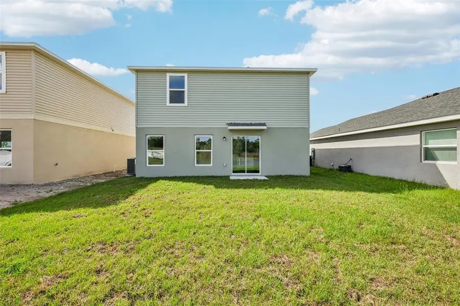 Exterior details and patio area of a home in Eagle Hammock, Eagle Lake (Image 3).