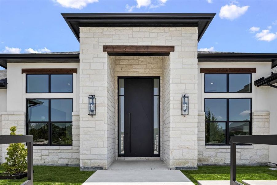 Entrance to property featuring stone siding