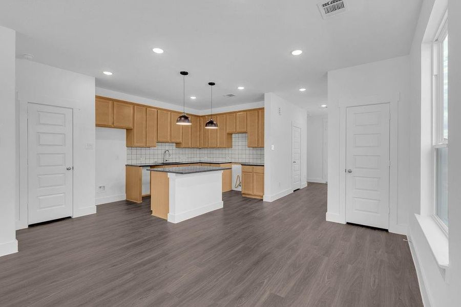 High Ceilings and Luxury Vinyl Plank Flooring Throughout Main Living Areas