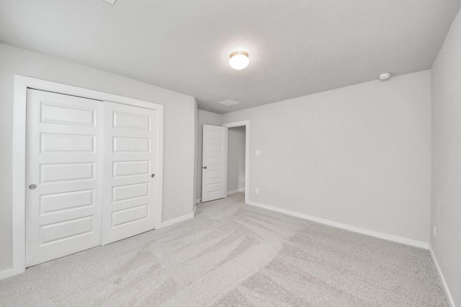 Generously sized secondary bedrooms featuring spacious closets, soft and inviting carpeting underfoot, large windows allowing plenty of natural light, and the added touch of privacy blinds for your personal retreat. Sample photo of completed home with similar floor plan. Actual colors and selections may vary. Generously sized secondary bedrooms featuring spacious closets, soft and inviting carpeting underfoot, large windows allowing plenty of natural light, and the added touch of privacy blinds for your personal retreat. Sample photo of completed home with similar floor plan. Actual colors and selections may vary.