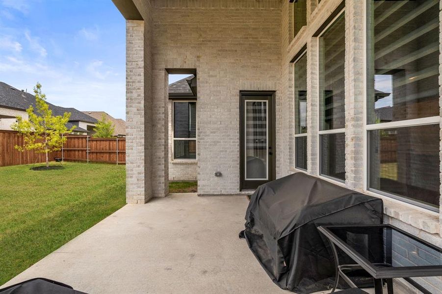 Fenced backyard with a large covered patio area