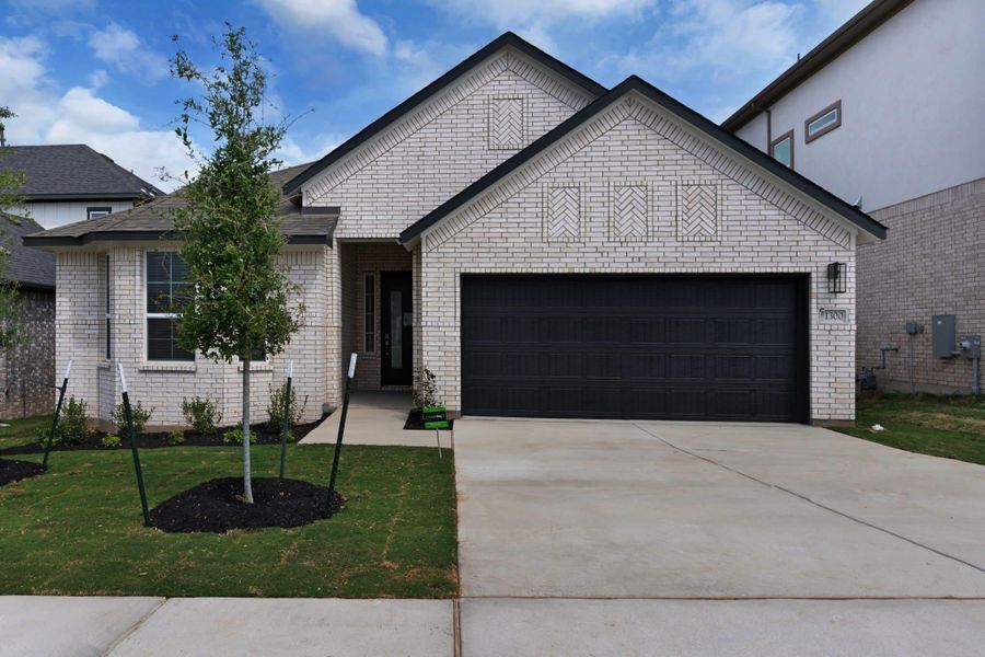 Front exterior of a new home in University Heights, Round Rock, TX, highlighting curb appeal (Image 26).