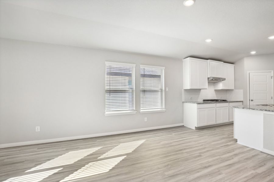 Dining room and kitchen in the Oleander floorplan at a Meritage Homes community. Dining room and kitchen in the Oleander floorplan at a Meritage Homes community.