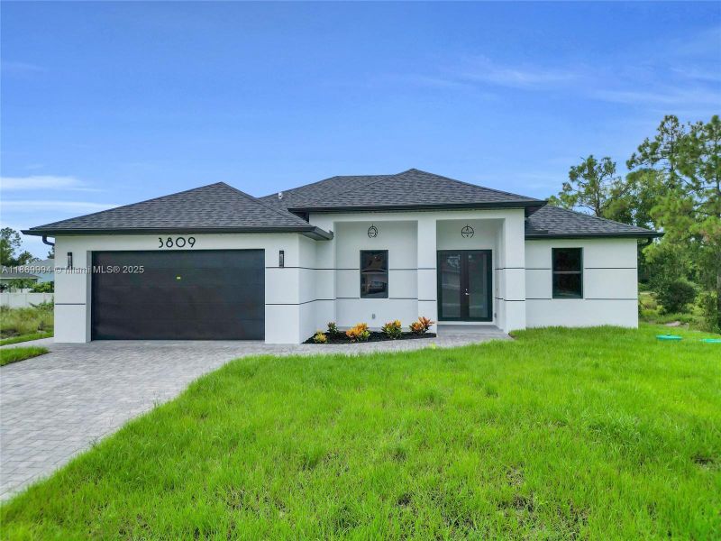 Front exterior of a new home in , Lehigh Acres, FL, highlighting curb appeal (Image 16).