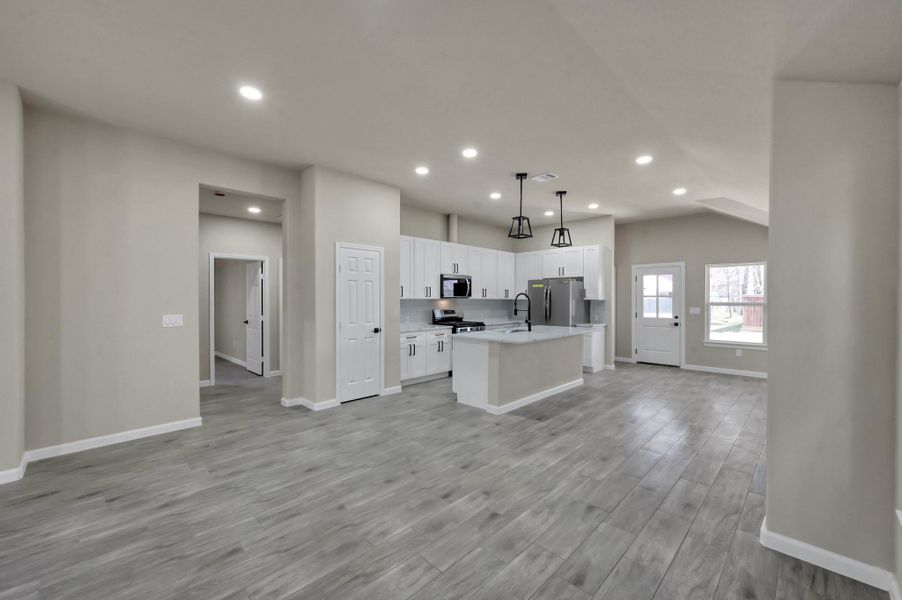 High-style meets function with recessed LED lighting, modern matte black fixtures, and a clear view into the private backyard.