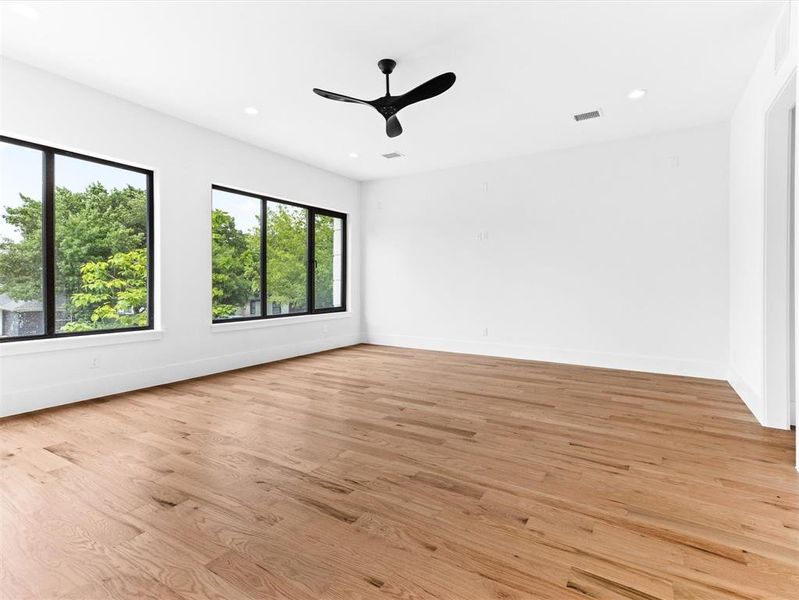 Spare room featuring ceiling fan and light wood-type flooring