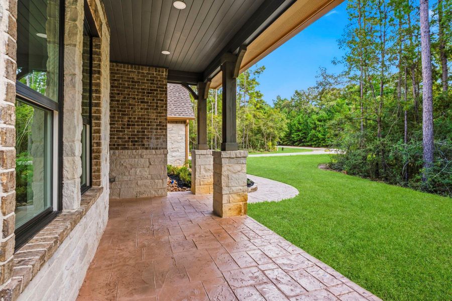 The expansive covered porch invites you to slow down and enjoy the serene surroundings.