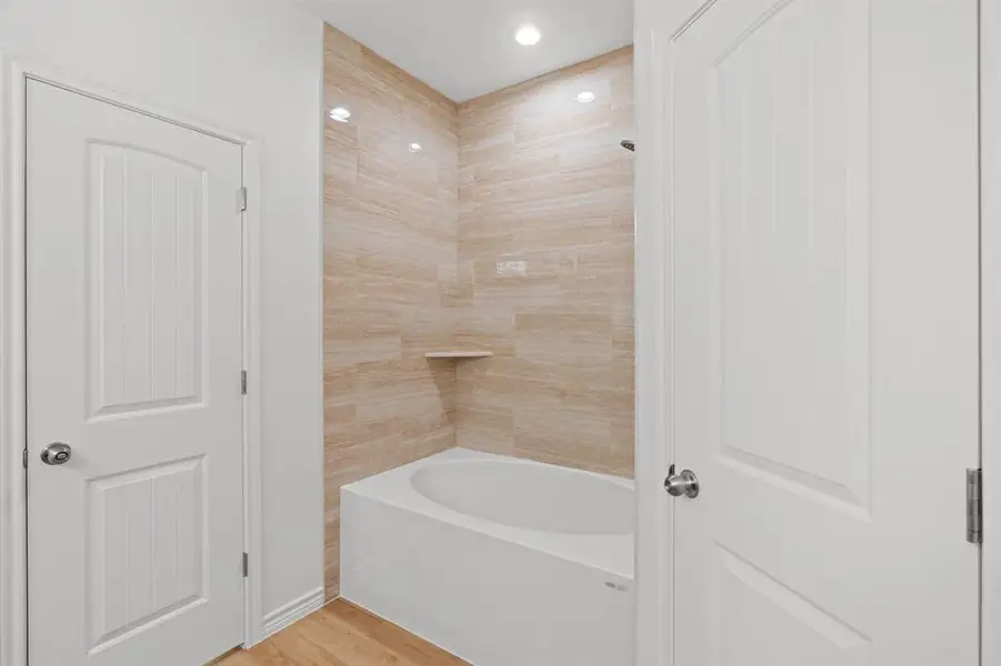 Full bath with wood finished floors, recessed lighting, and shower / tub combination Full bath with wood finished floors, recessed lighting, and shower / tub combination