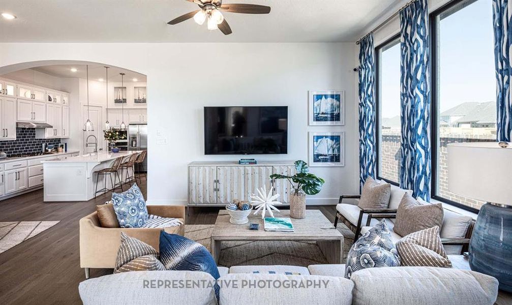 Living area with dark wood-type flooring, ceiling fan, and recessed lighting Living area with dark wood-type flooring, ceiling fan, and recessed lighting