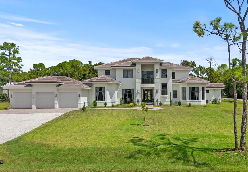 Front exterior of a new home in , Palm Beach Gardens, FL, highlighting curb appeal (Image 1).