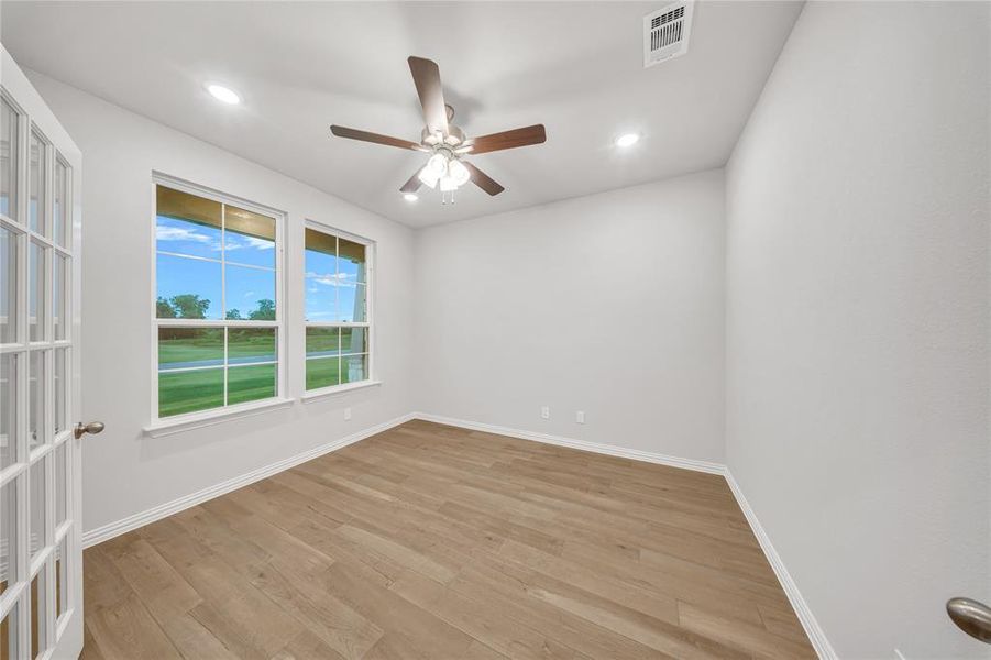 Spare room featuring a ceiling fan, light wood-type flooring, and recessed lighting Spare room featuring a ceiling fan, light wood-type flooring, and recessed lighting