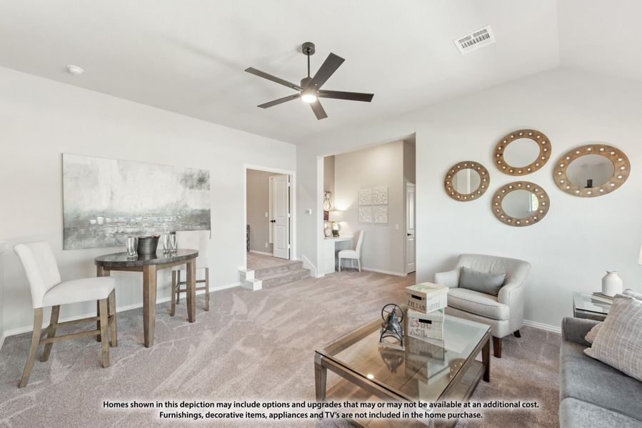 Open living room with carpet, ceiling fan, glass coffee table, and decorative mirrors on the wall Open living room with carpet, ceiling fan, glass coffee table, and decorative mirrors on the wall