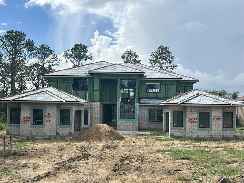 Front exterior of a new home in Bella Collina, Montverde, FL, highlighting curb appeal (Image 1).