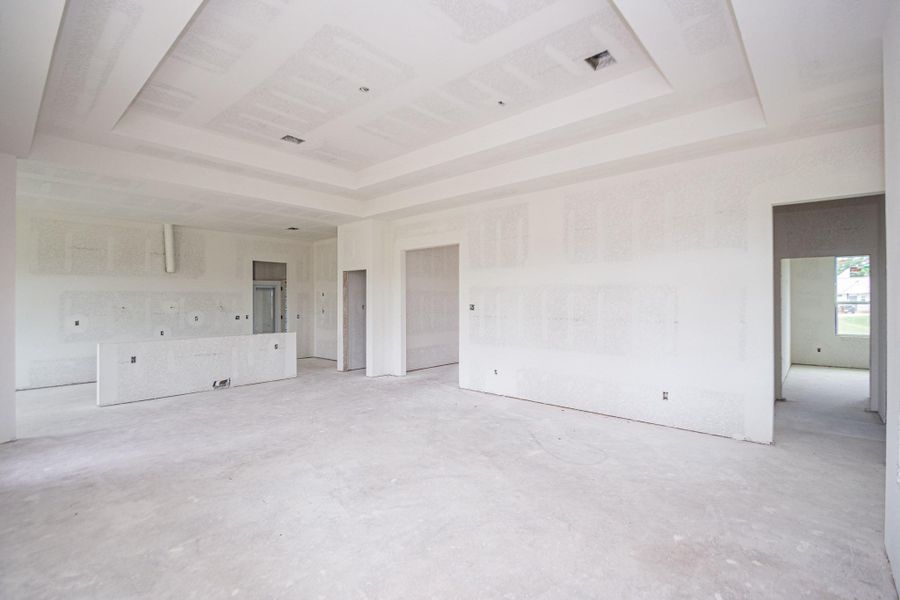 Spacious unfinished living room with high ceilings and ample natural light, ready for customization to suit your style and needs. Spacious unfinished living room with high ceilings and ample natural light, ready for customization to suit your style and needs.