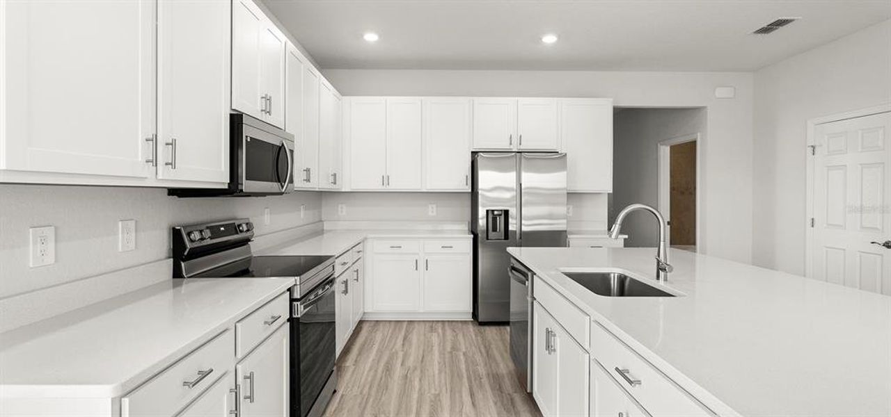 Furnished interior view inside a new home in Estates at Hickory Cove - Bungalows, St. Cloud (Image 7).
