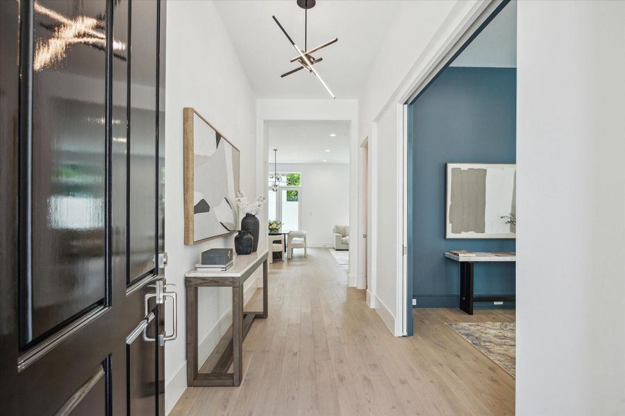 Step into this bright and welcoming formal entry. The first floor living space features 11-foot ceilings, Legno Bastone engineered White Oak wood floors, and designer light fixtures. Step into this bright and welcoming formal entry. The first floor living space features 11-foot ceilings, Legno Bastone engineered White Oak wood floors, and designer light fixtures.
